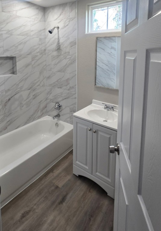 4834 Clover Street Houston, TX 77033 - Photo 9 of 10 a bathroom with a sink a mirror and a bathtub