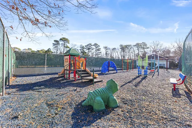 a childrens park with lots of swings slides and swimming pool