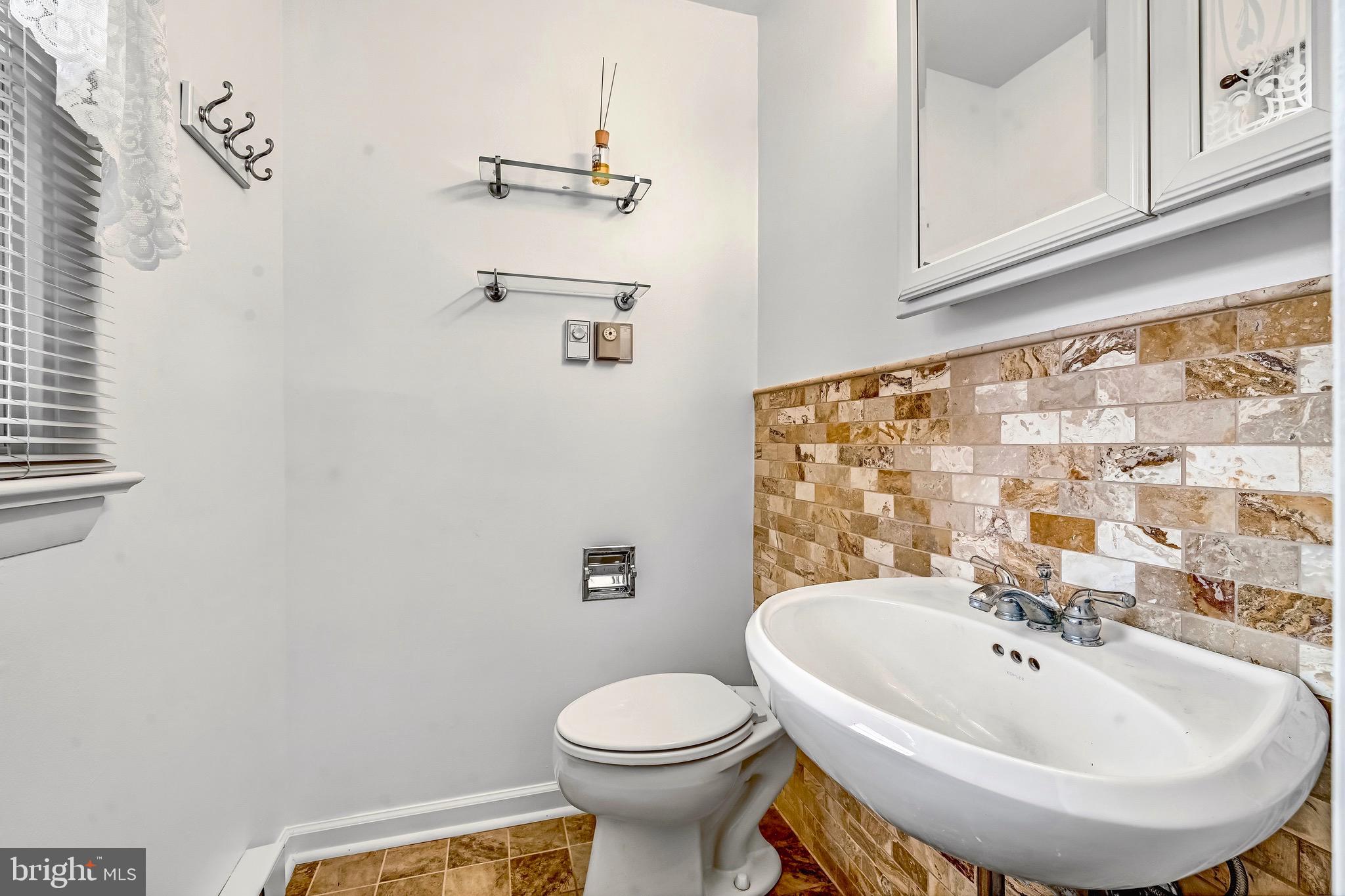 6827 Bellevue Road Royal Oak, MD 21662 - Photo 15 of 32 a bathroom with a sink and a mirror