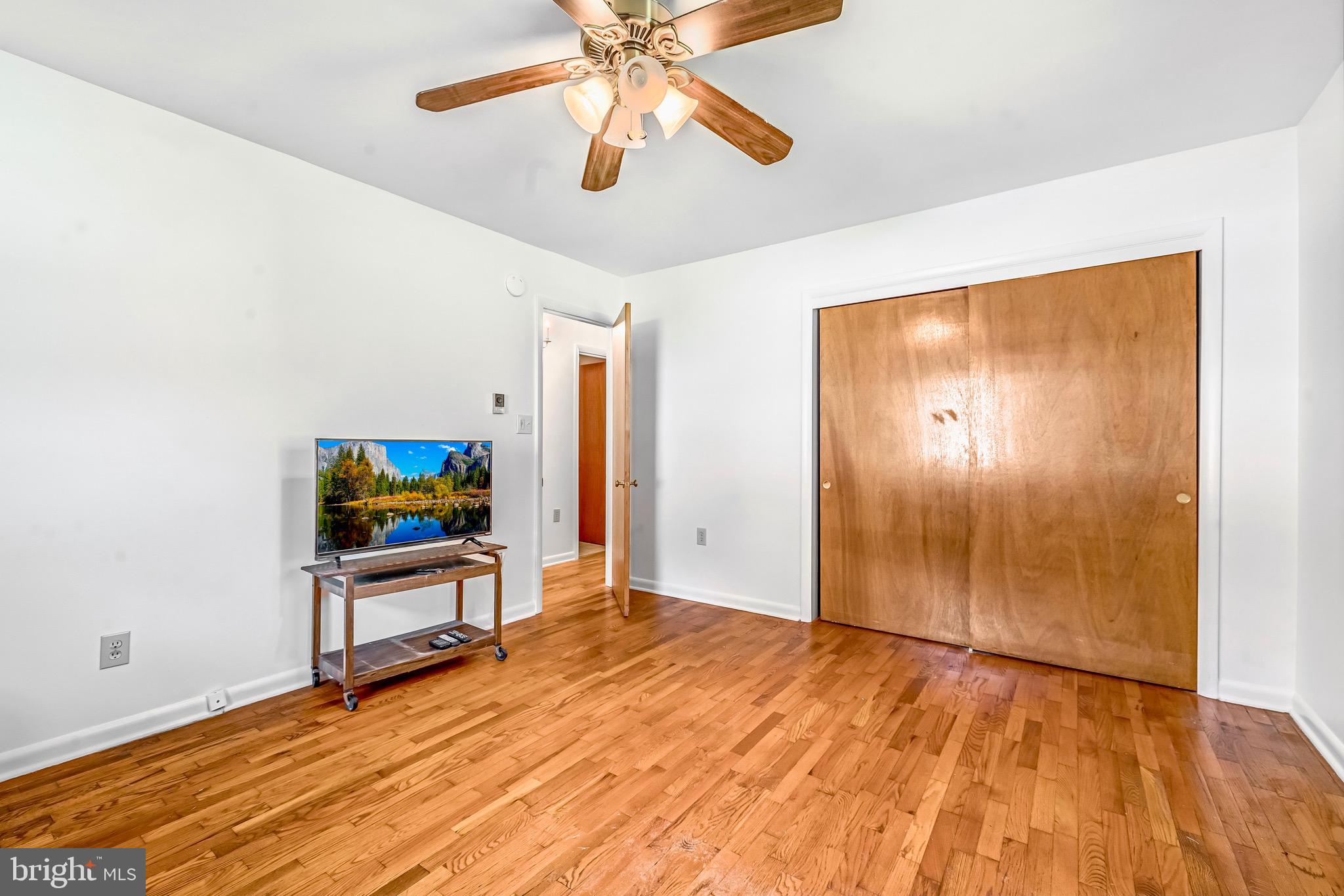 6827 Bellevue Road Royal Oak, MD 21662 - Photo 19 of 32 a view of an empty room with a window and wooden floor
