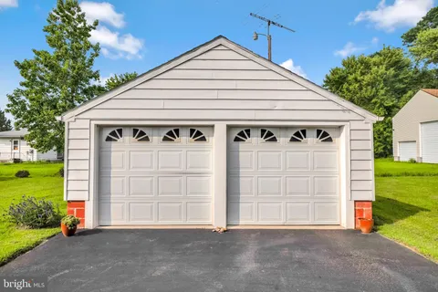 a view of a house with a yard and garage
