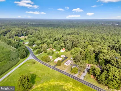 an aerial view of residential houses with outdoor space and swimming pool