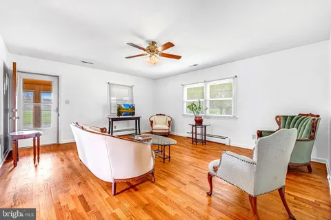 a living room with furniture a window and a table