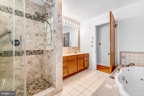 a bathroom with a tub sink and shower