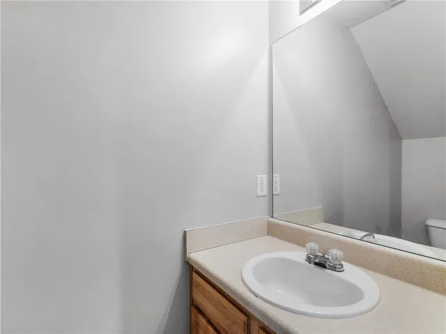 a bathroom with a sink a mirror and a toilet