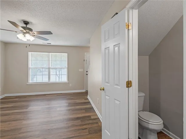 a view of a room with wooden floor and windows