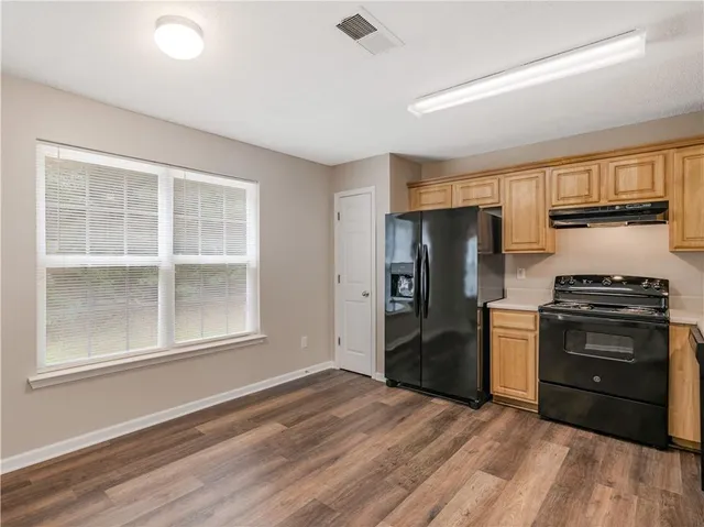 a kitchen with stainless steel appliances granite countertop a stove and a refrigerator