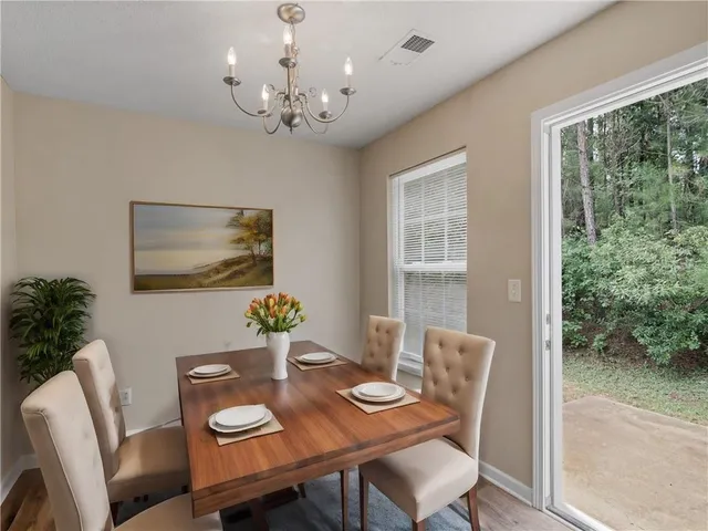 a view of a dining room with furniture window and outside view