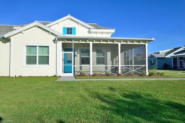 a view of a house with a yard and sitting area