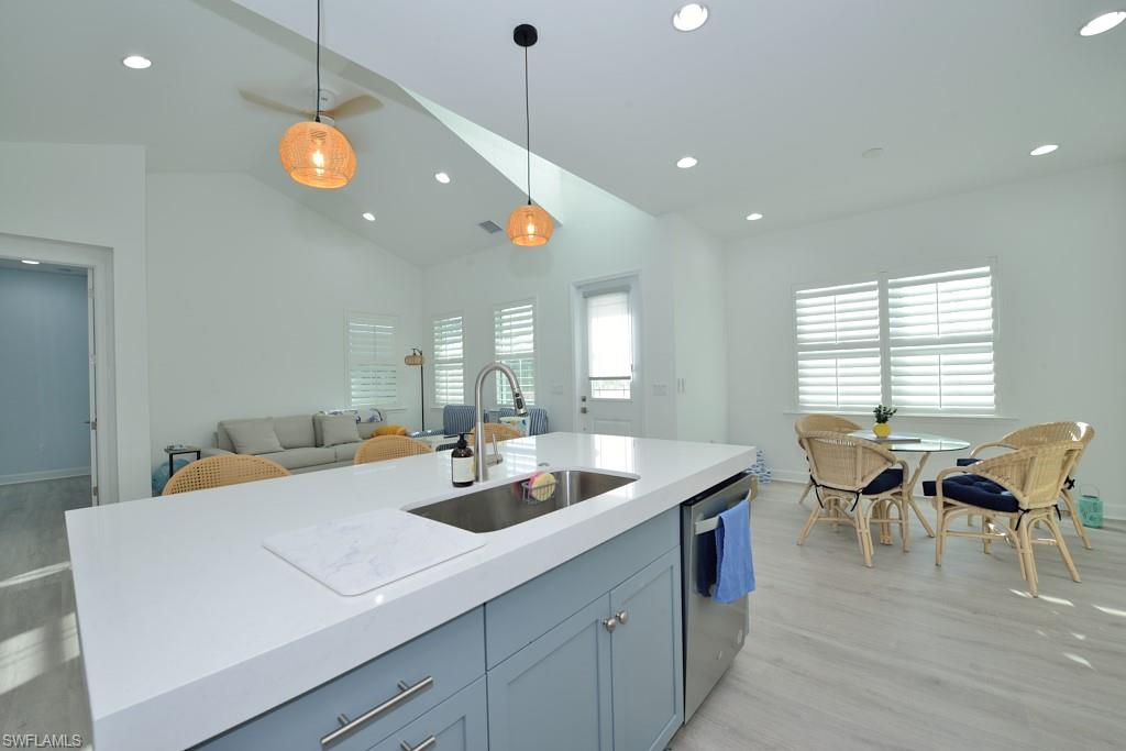 7259 Cayo Coco Lane Naples, FL 34113 - Photo 3 of 20 a view of a dining room and livingroom with furniture wooden floor a chandelier