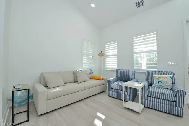 a living room with furniture and windows
