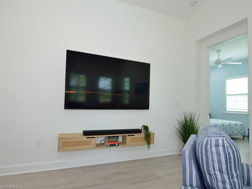 7259 Cayo Coco Lane Naples, FL 34113 - Photo 6 of 20 a living room with furniture and a flat screen tv