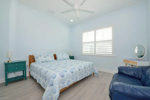 a bedroom with a bed couch and window