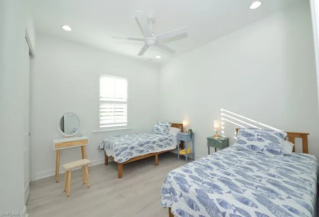 a bedroom with two beds and a table