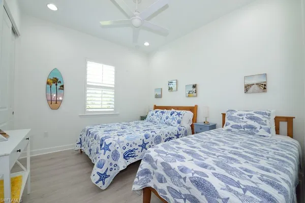 a bedroom with two beds and a window