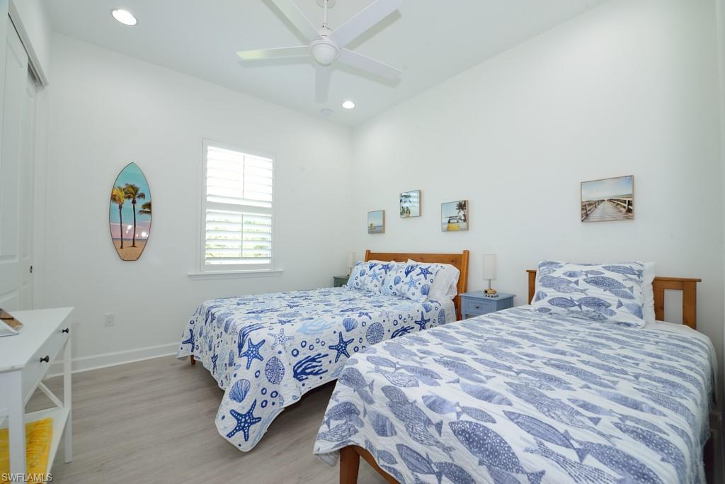 7259 Cayo Coco Lane Naples, FL 34113 - Photo 10 of 20 a bedroom with two beds and a window