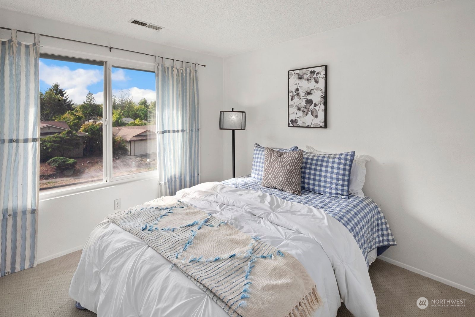 924 South 29th Court Renton, WA 98055 - Photo 19 of 27 a bedroom with a large bed and a large window