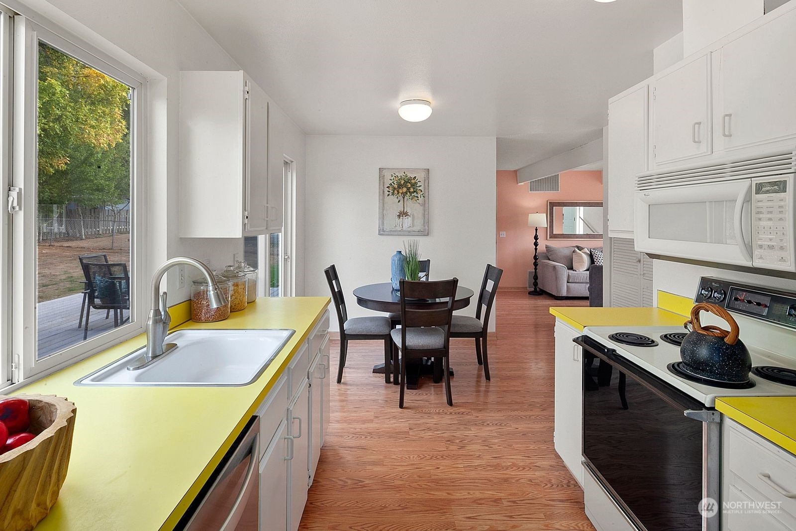 924 South 29th Court Renton, WA 98055 - Photo 7 of 27 a kitchen with a table chairs and a stove
