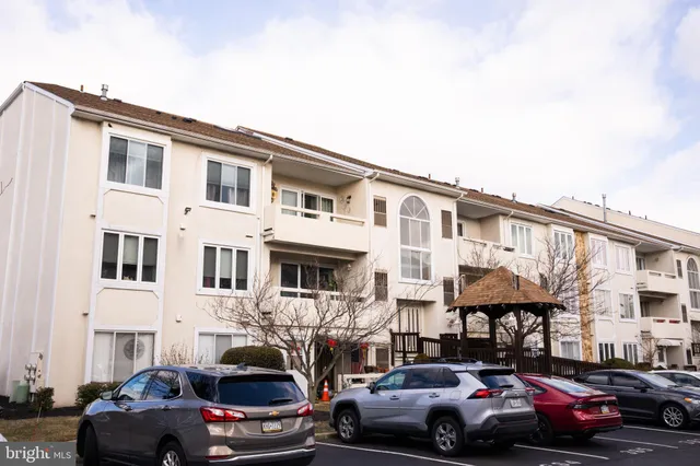 a couple of cars parked in front of a house