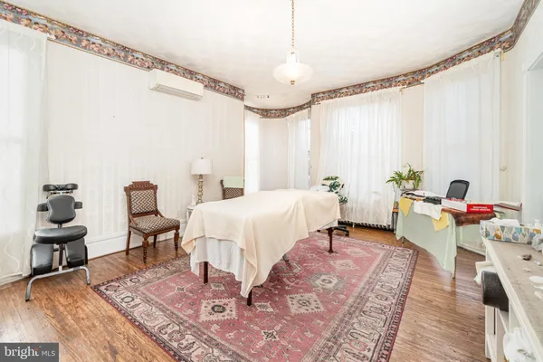 a living room with furniture a large window and a flat screen tv