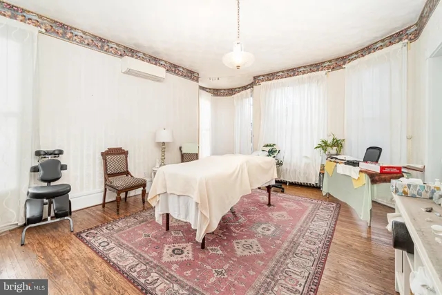 a living room with furniture a large window and a flat screen tv