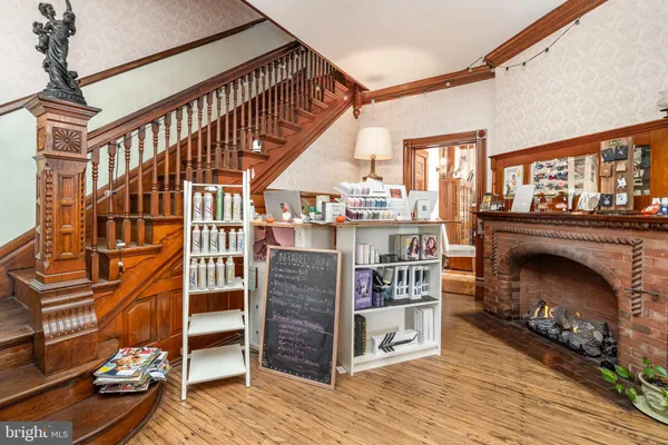 a living room with furniture a chandelier and large window