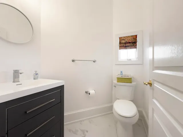 a bathroom with a sink a toilet and a mirror