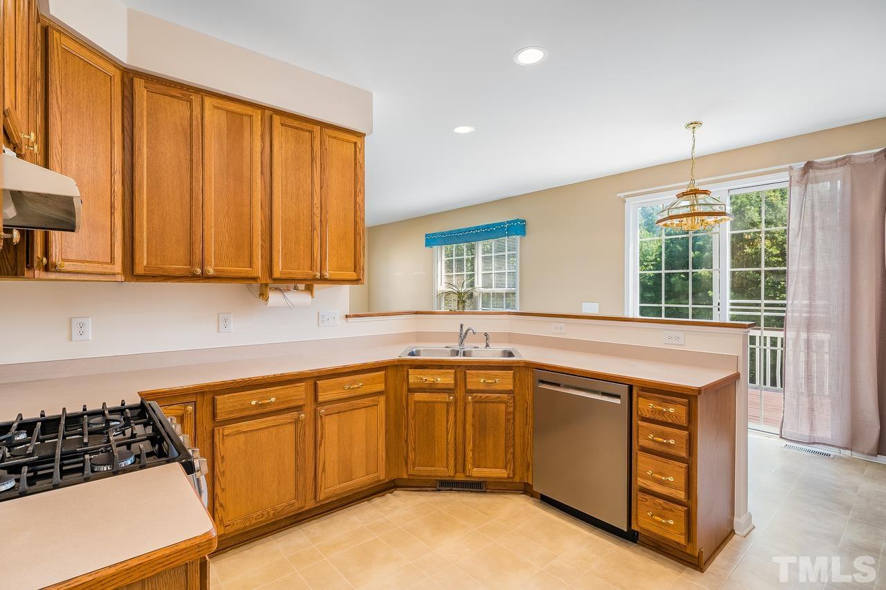 664 Seastone Street Raleigh, NC 27603 - Photo 11 of 25 a kitchen that has a sink and a stove in it