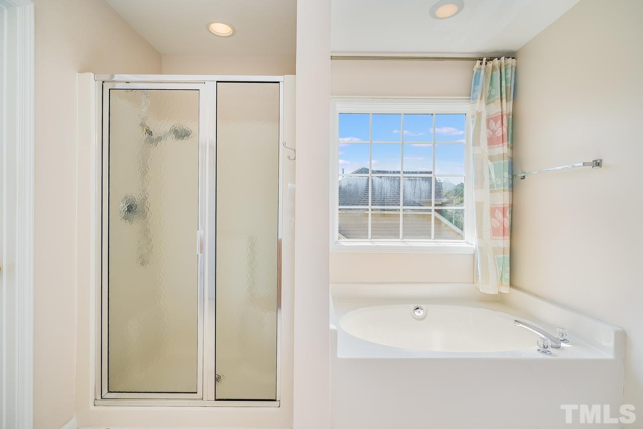 664 Seastone Street Raleigh, NC 27603 - Photo 23 of 25 a bathroom with a bathtub and a shower