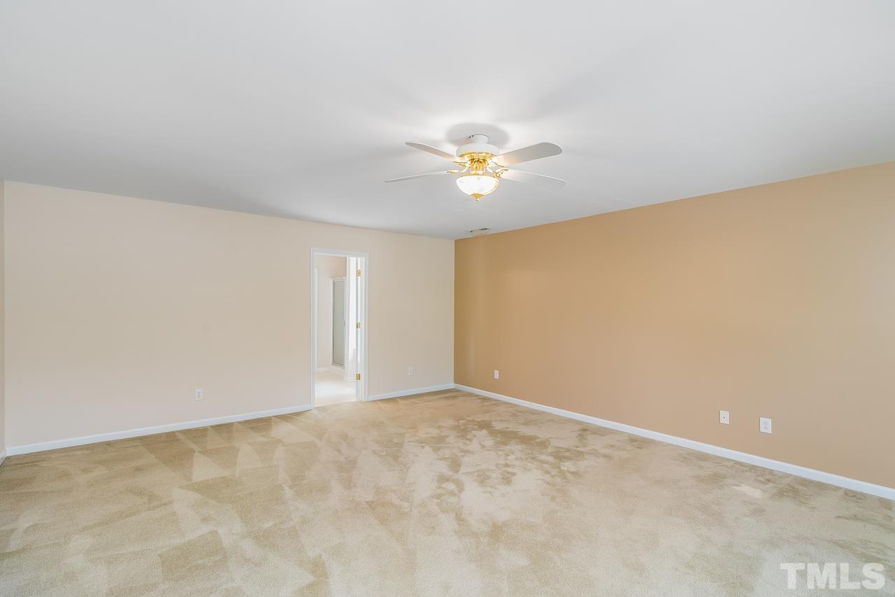 664 Seastone Street Raleigh, NC 27603 - Photo 25 of 25 an empty room with a window and a ceiling fan