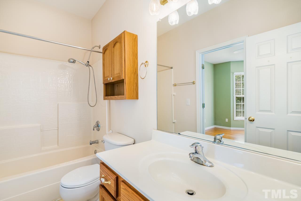 664 Seastone Street Raleigh, NC 27603 - Photo 8 of 25 a bathroom with a sink a toilet and a bathtub