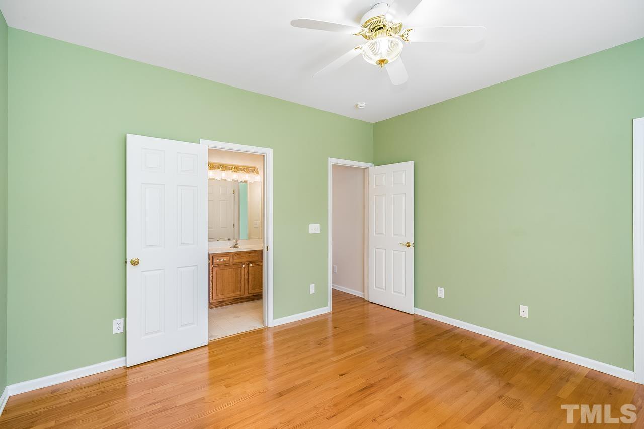 664 Seastone Street Raleigh, NC 27603 - Photo 10 of 25 a view of an empty room with wooden floor and a window