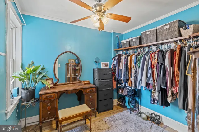 a view of walk in closet with clothes and shoes