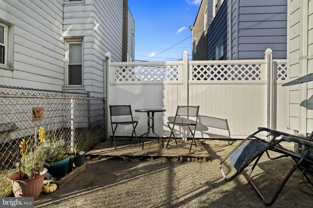 a view of a chairs and table in backyard