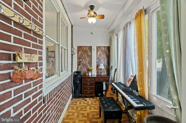 a living room with furniture lamp and a large window
