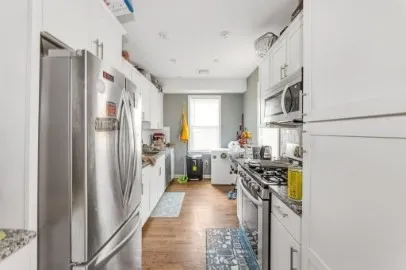 a kitchen with stainless steel appliances a refrigerator a stove a sink and a refrigerator