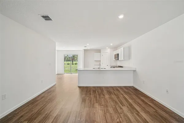 a large kitchen with stainless steel appliances granite countertop a stove and a sink