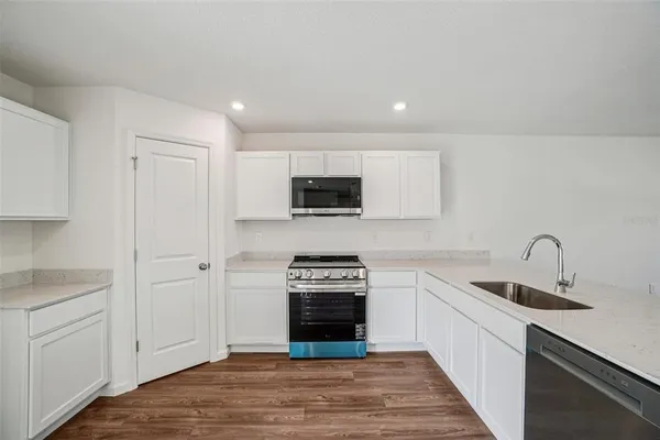 a view of hallway with wooden floor