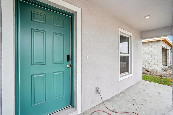 a large white kitchen with white cabinets and wooden floor
