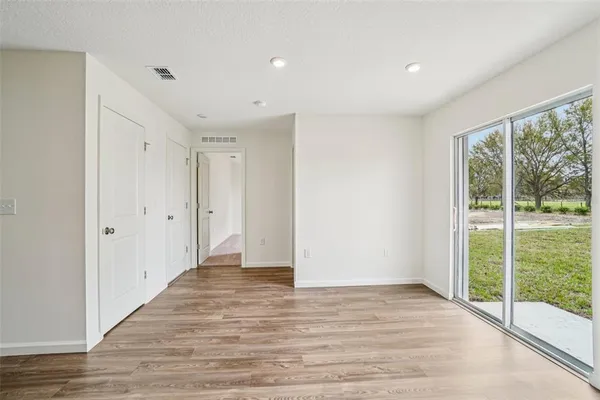 a view of kitchen with wooden floor and electronic appliances