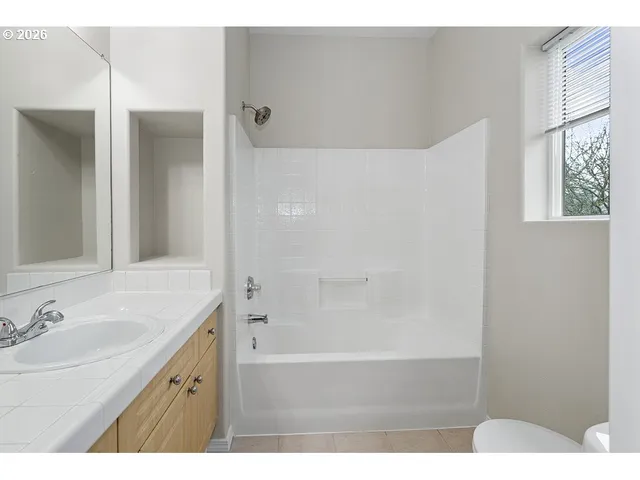 a bathroom with a sink a mirror and a shower
