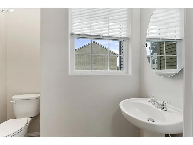 a bathroom with a sink toilet and a mirror