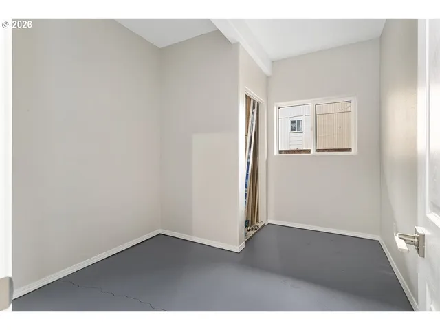 an empty room with wooden floor