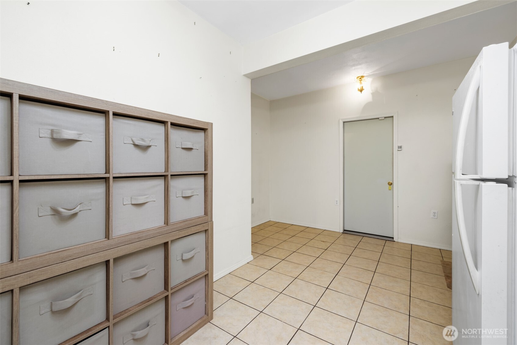 453 Stampede Drive Sequim, WA 98382 - Photo 26 of 36 a view of a refrigerator in kitchen and an empty room