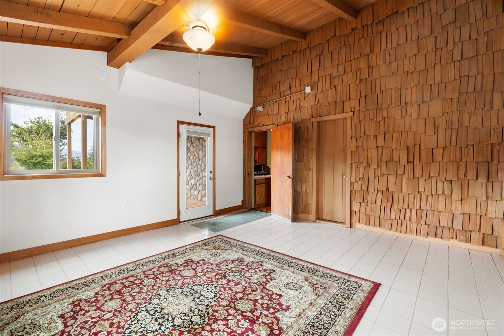 453 Stampede Drive Sequim, WA 98382 - Photo 27 of 36 a view of a big room with wooden floor and windows