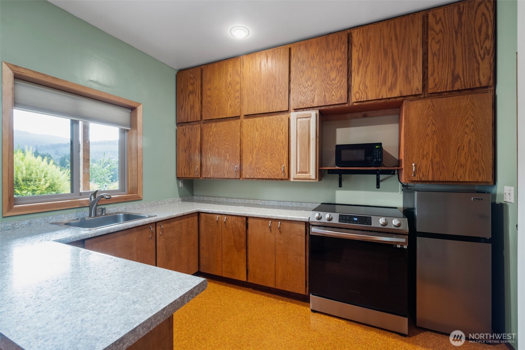 453 Stampede Drive Sequim, WA 98382 - Photo 29 of 36 a kitchen with stainless steel appliances granite countertop a stove a sink and a microwave