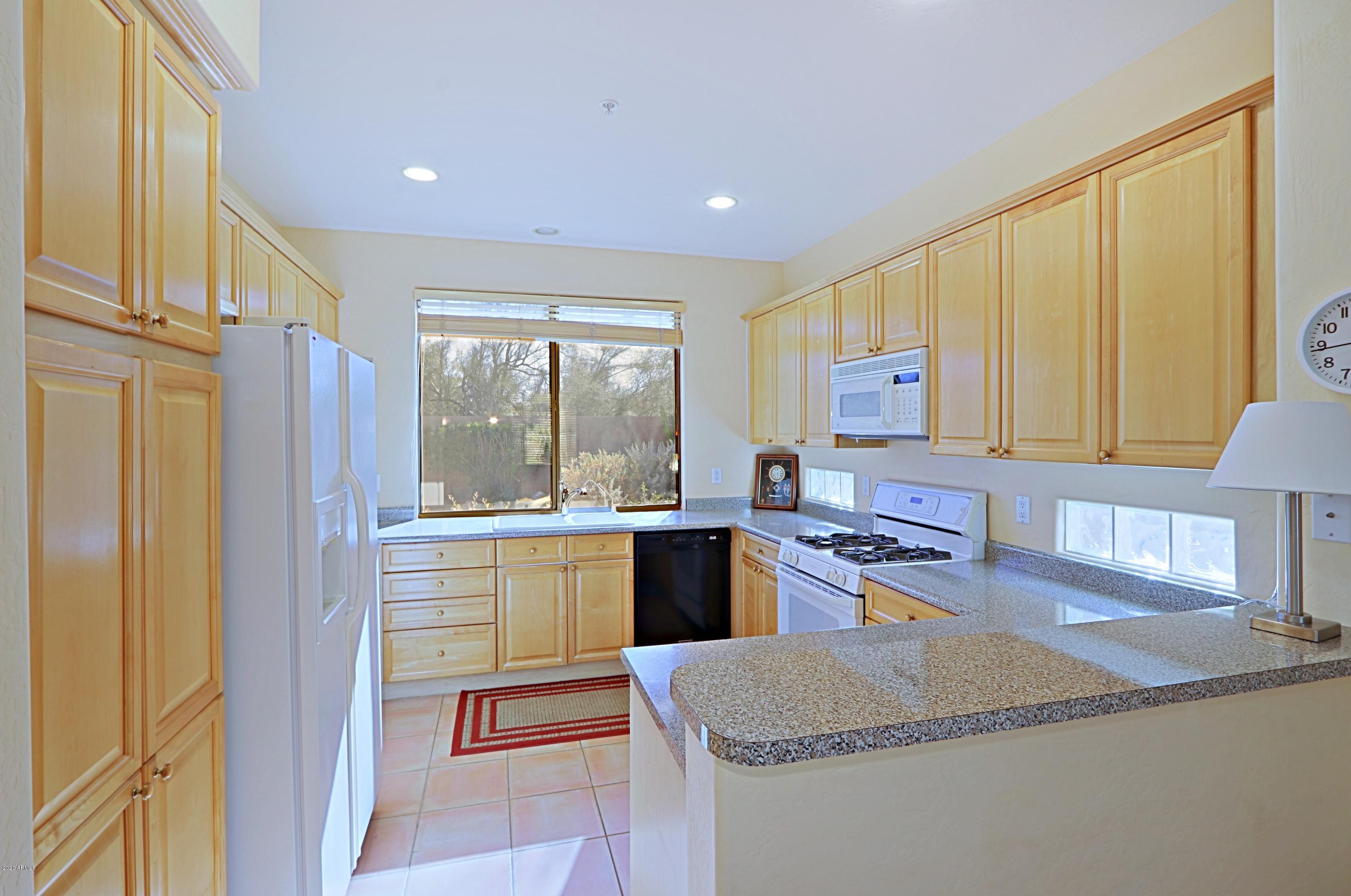 6803 East Eagle Feather Road Scottsdale, AZ 85266 - Photo 9 of 67 a kitchen with sink refrigerator and stove