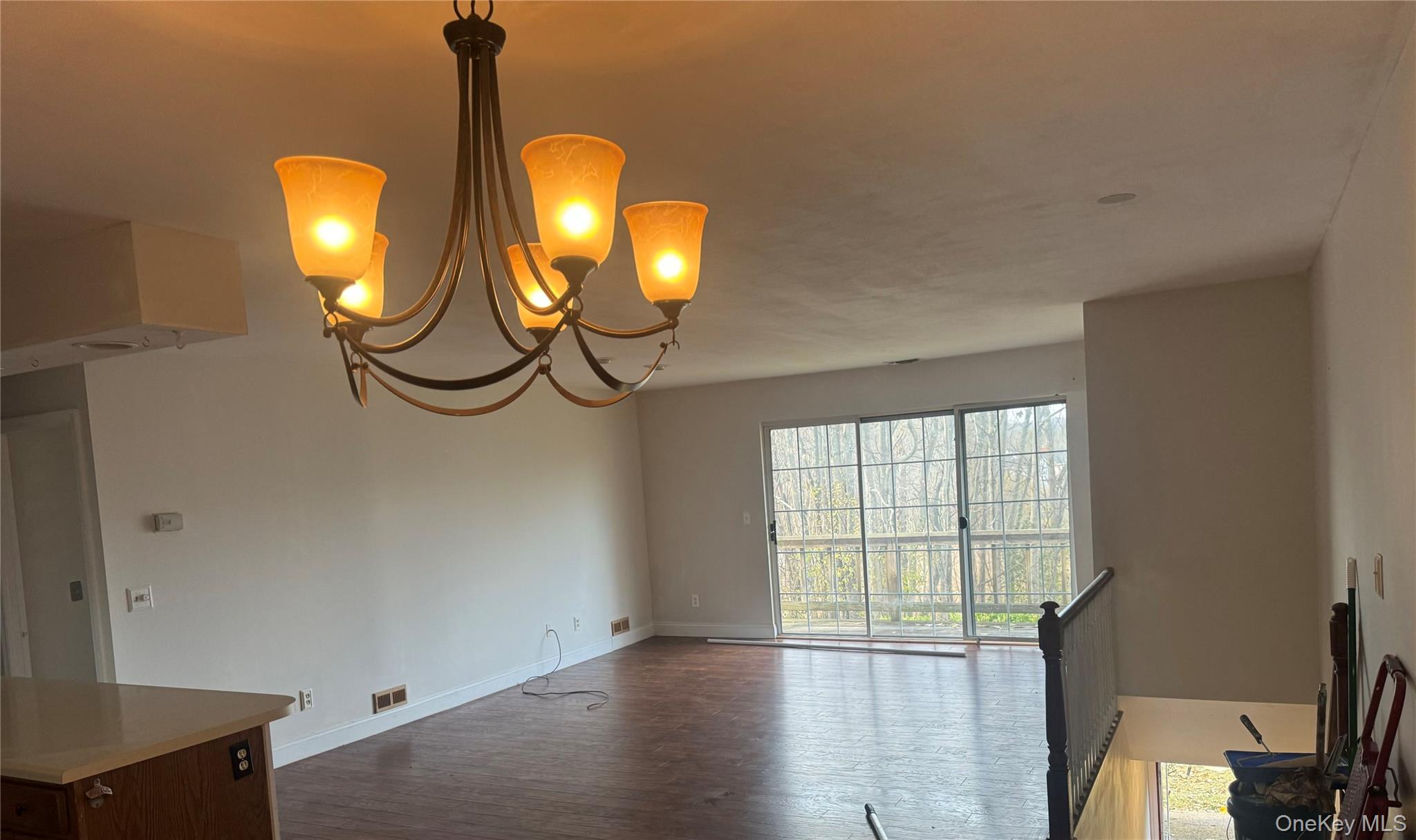 11 The Rise Warwick, NY 10990 - Photo 5 of 11 Unfurnished dining area featuring dark wood-style floors and a chandelier