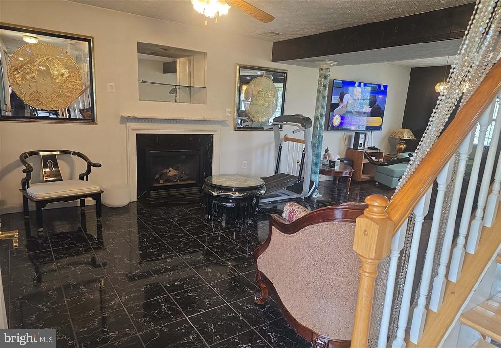 2448 Shellcove Court Waldorf, MD 20601 - Photo 15 of 18 a living room with furniture a flat screen tv and a fireplace