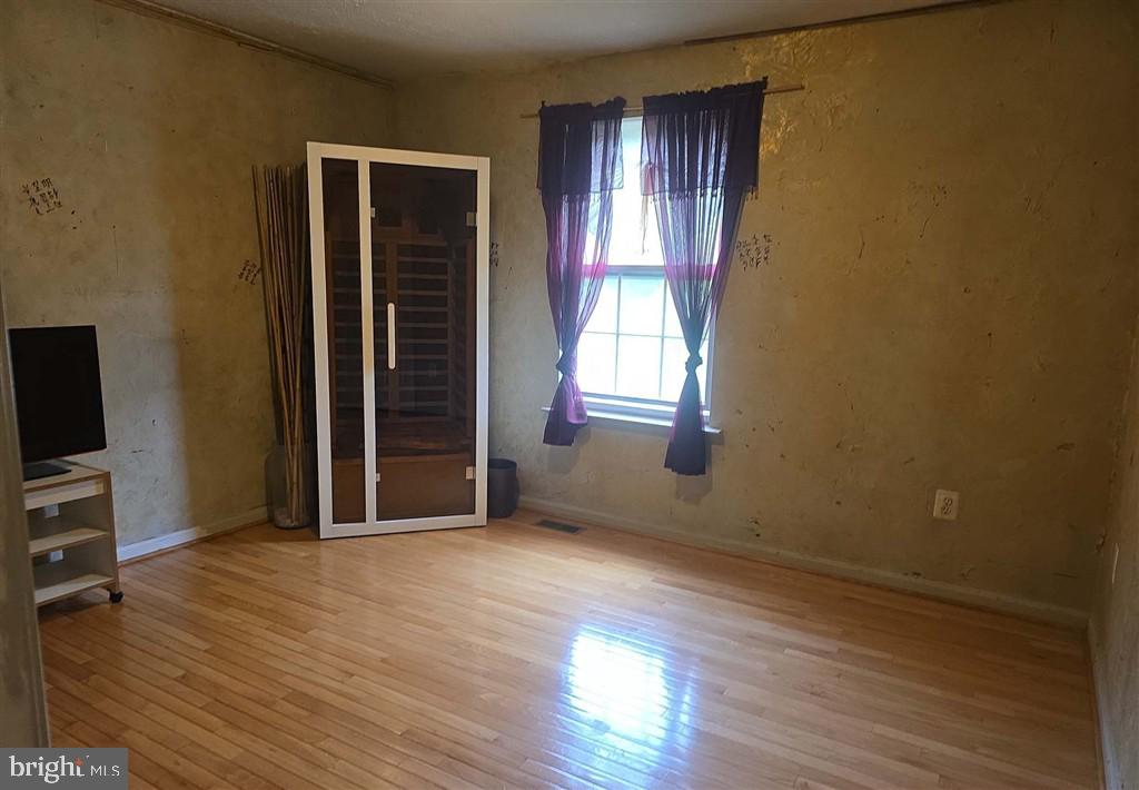 2448 Shellcove Court Waldorf, MD 20601 - Photo 6 of 18 an empty room with wooden floor and windows
